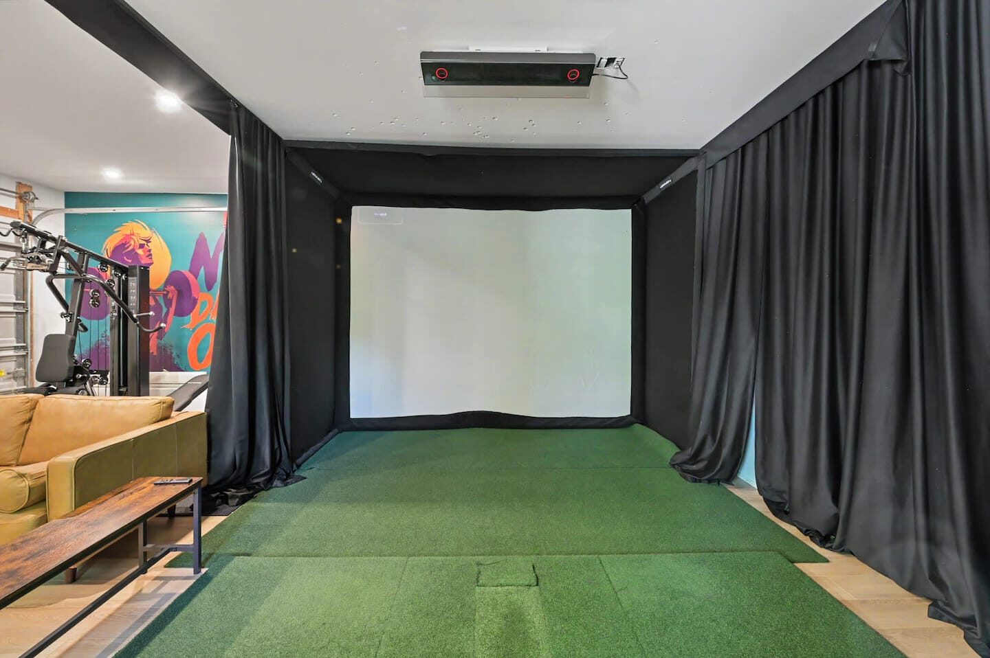 Indoor golf simulator with a large projection screen