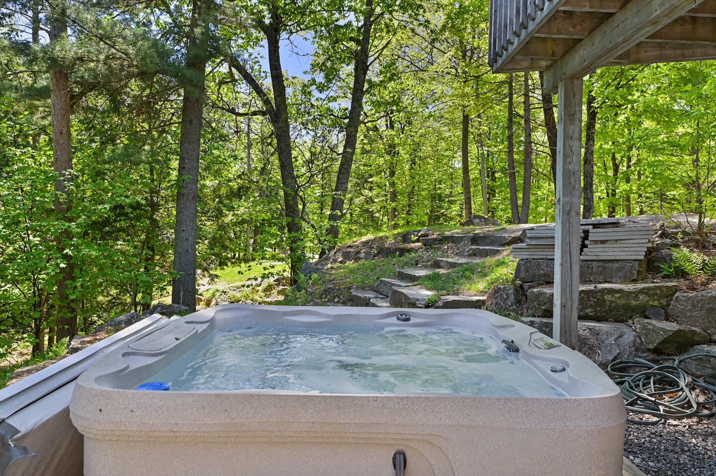 Outdoor hot tub set among the rocks and trees